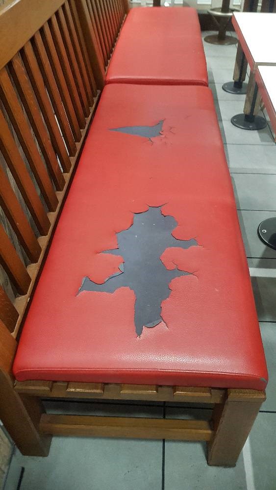 Before photo of a red leather bench