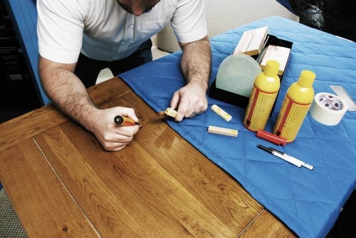 Technician Repairing the wooden table