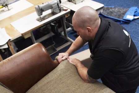 technician applying french polish to a table