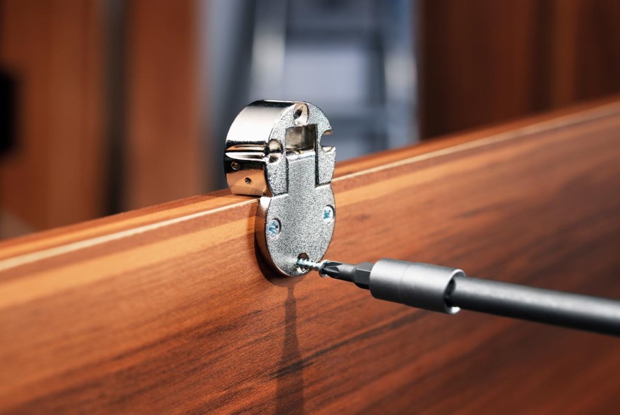 The replacement of a hinge on a wooden cabinet