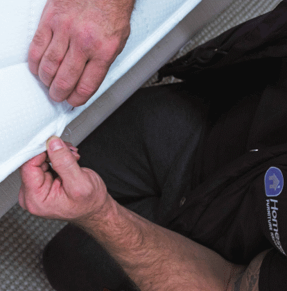 Technician in the process of checking the mattress for any defects